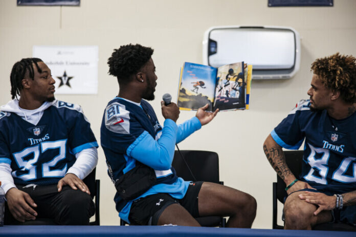 Charles McClelland #38 of the Tennessee Titans, Wide receiver Tre'Shaun Harrison #82 of the Tennessee Titans and Wide receiver Gavin Holmes #84 of the Tennessee Titans at Purpose Preparatory Academy during Rookies Read Across Nashville on June 21, 2023 in Nashville, TN. Photo By Emily Starkey /Tennessee Titans